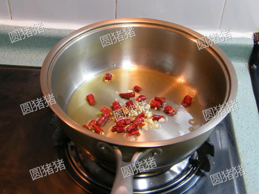 Short dried red chili sections warming in a lightly oiled clean skillet.