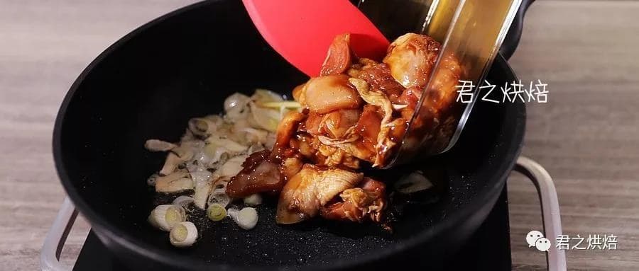 Marinated chicken tipped into the pan with the aromatics.