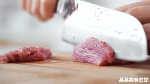 Beef sliced thinly across the grain; a still frame from the source cooking sequence.