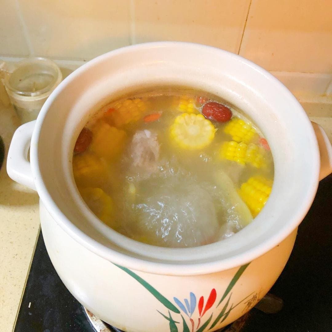 Corn, carrots, pork ribs and red dates simmering together in a soup pot.